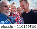 Happy family of three generations posing at camera together 110129500