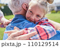 Portrait of cute girl embracing her lovely senior grandfather 110129514