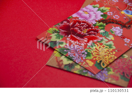 Close up of colorful envelope on red cover background with customizable space for text 110130531