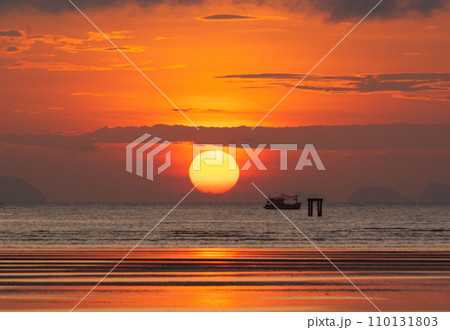 Beautiful sunrise in the morning at Saphanhin public beach, Phuket, Thailand. Beautiful sunrise in the morning at Saphanhin public beach, Phuket, Thailand. 110131803