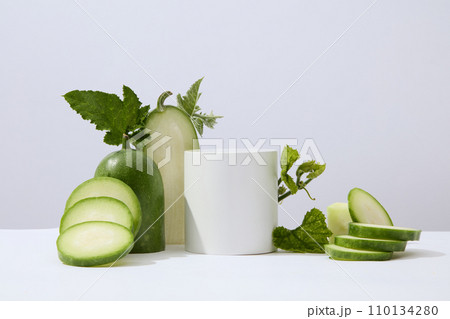 White background featured a cylinder podium white winter melon and green leaves. Studio podium or platform product template mockup of Winter melon (Benincasa hispida) extract White background featured a cylinder podium white winter melon and green leaves. Studio podium or platform product template mockup of Winter melon (Benincasa hispida) extract 110134280