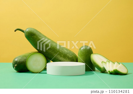 A podium in round shaped decorated with winter melon slices. Front view. Winter melon (Benincasa hispida) may help protect body against cell damage A podium in round shaped decorated with winter melon slices. Front view. Winter melon (Benincasa hispida) may help protect body against cell damage 110134281