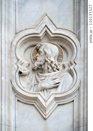 Saint, relief on the facade of Basilica of Santa Croce (Basilica of the Holy Cross) - famous Franciscan church in Florence, Italy 110135527