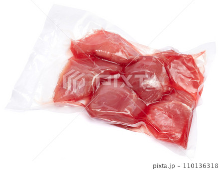 close-up Vacuum packed tuna fillet pieces in transparent plastic for preserving the freshness isolated on white background 110136318