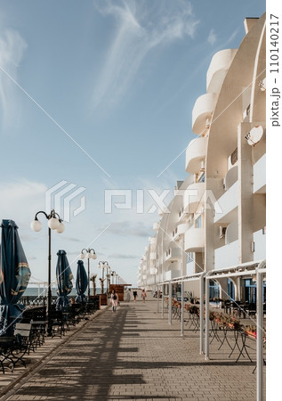 Coastal residential areas with a modern hotel and restaurant complex alongside sandy beaches. Summer holiday vacation and travel concept. Coastal residential areas with a modern hotel and restaurant complex alongside sandy beaches. Summer holiday vacation and travel concept. 110140217