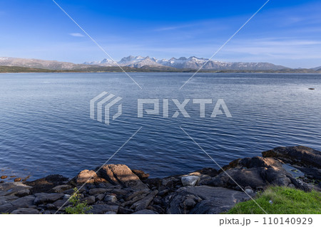 Snow-capped mountains and large boulders frame Saltfjorden near Bodo 110140929