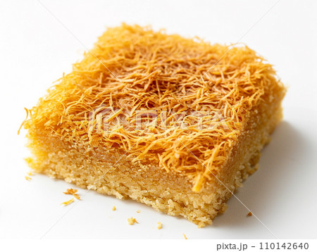 Close-up of Arabic dessert Kunafa on a white background. Close-up of Arabic dessert Kunafa on a white background. 110142640