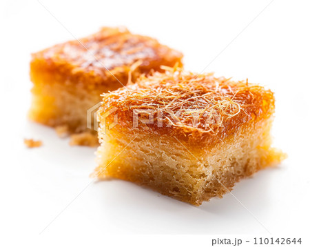 Close-up of Arabic dessert Kunafa on a white background. Close-up of Arabic dessert Kunafa on a white background. 110142644