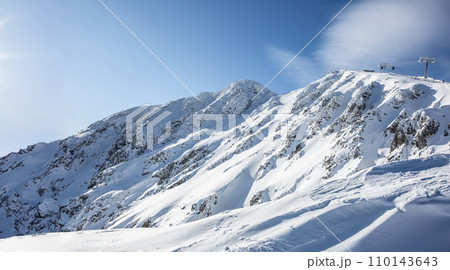 View of the snow-covered hills of the Low Tatras - Jasna and the cable car that takes skiers to Chopok mountain View of the snow-covered hills of the Low Tatras - Jasna and the cable car that takes skiers to Chopok mountain 110143643