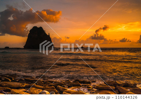 Sunset at the rocky beach in Papuma, Jember, East Java, Indonesia 110144326