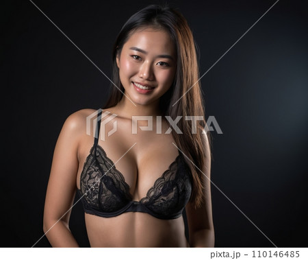beautiful asian woman in black lingerie posing on black background 110146485