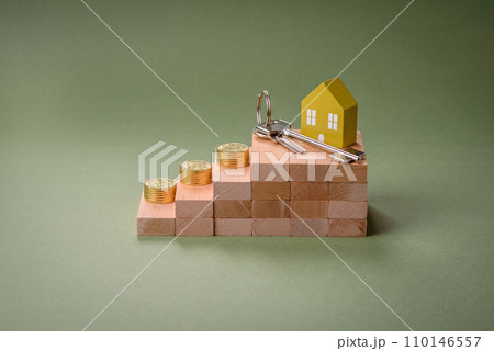 A small wooden house and keys as an idea for investing in your own home 110146557