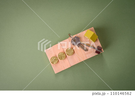 A small wooden house and keys as an idea for investing in your own home A small wooden house and keys as an idea for investing in your own home 110146562
