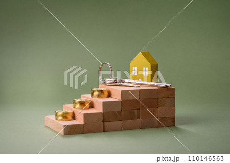 A small wooden house and keys as an idea for investing in your own home A small wooden house and keys as an idea for investing in your own home 110146563