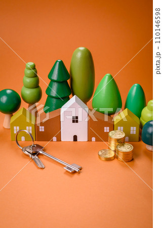 A small wooden house and keys as an idea for investing in your own home 110146598