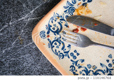 Empty plate after eating on table Empty plate after eating on table 110146768