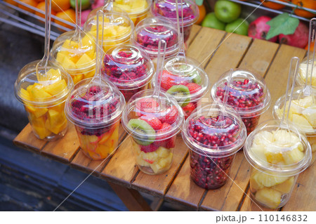 pineapple, kiwi and Strawberries in. plastic container selling at shop pineapple, kiwi and Strawberries in. plastic container selling at shop 110146832
