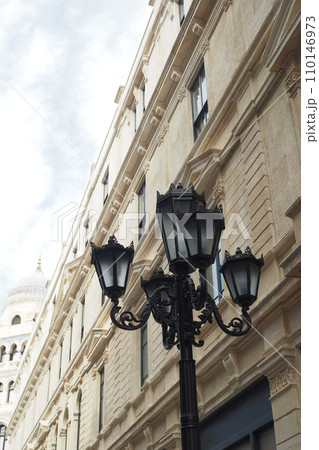 Elegant street lamp surrounded by buildings  110146973