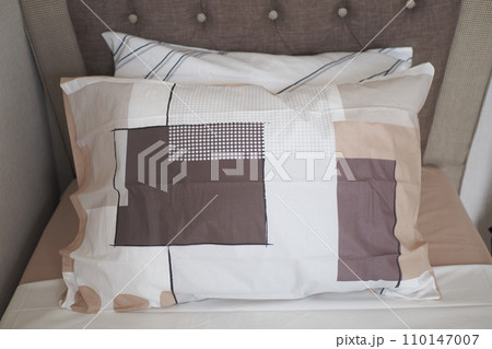 bed and brown pillows in modern bedroom 110147007