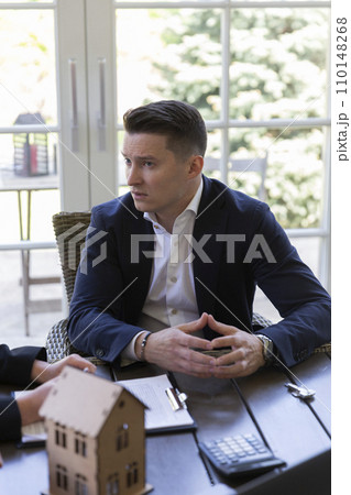 Businessman consults with realtor about buying house 110148268