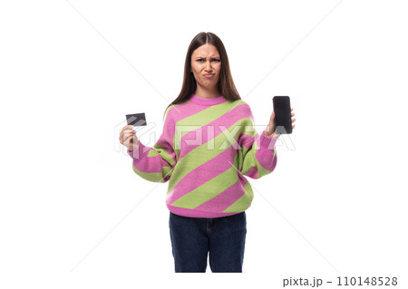 young slender caucasian woman with straight black hair is dressed in a striped pink pullover holding young slender caucasian woman with straight black hair is dressed in a striped pink pullover holding 110148528