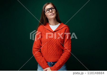 Smart Caucasian woman with brown straight hair and glasses on green background 110148664
