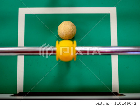 top view on a foosball goalie blocking the ball insider the box 110149042