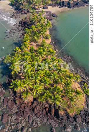 Aerial top view on tropical beach with green palm trees under sunlight Drone view in Goa Aerial top view on tropical beach with green palm trees under sunlight Drone view in Goa 110154704