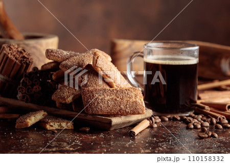 Sweet cinnamon cookies and a mug of black coffee. Sweet cinnamon cookies and a mug of black coffee. 110158332