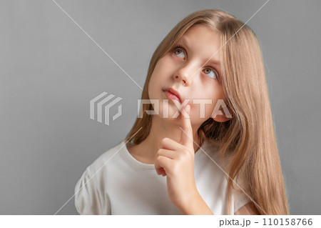 A thoughtful girl with long blond hair 110158766