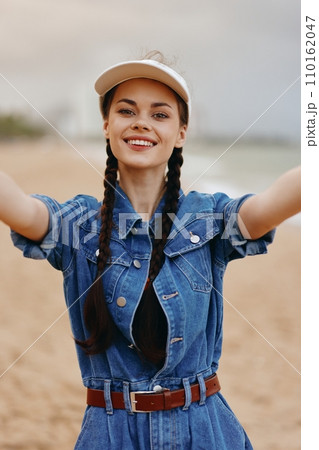 Happy young female portrait: Attractive woman enjoying a summer smile in nature. 110162047