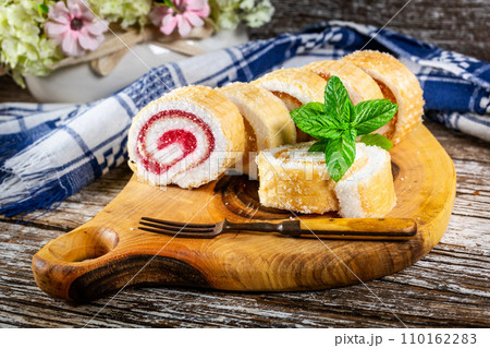 Slices of homemade sweet roll with fruit jam. Slices of homemade sweet roll with fruit jam. 110162283
