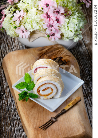 Slices of homemade sweet roll with fruit jam. 110162284