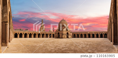 Inner yard of Mosque Ibn Tulun, wonderful sunset of a famous place of Cairo, Egypt 110163905