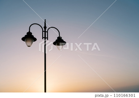 Street double lamp on the background of a colorful sunset 110166301