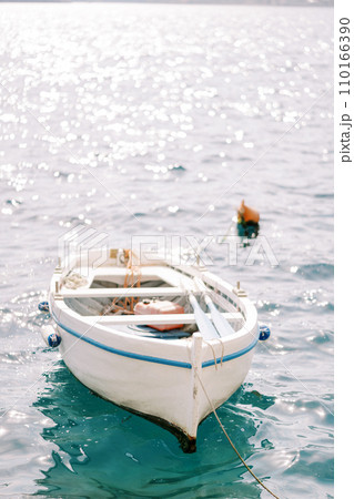 White fishing boat moored in the sea White fishing boat moored in the sea 110166390