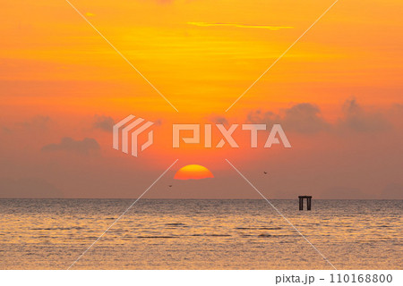 Beautiful sunrise at Saphanhin public beach, Phuket, Thailand. 110168800
