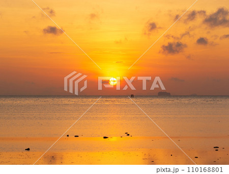 Beautiful sunrise at Saphanhin public beach, Phuket, Thailand. 110168801