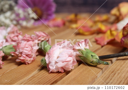 Old Flowers Drying on Wooden Table. Zinnias With Roses and Carnations 110172602