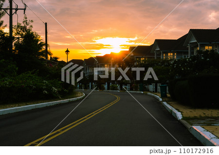 Modern cottages row road sidewalk two story buildings residential villas village New Estate Reflection dawn Sun in windows  110172916