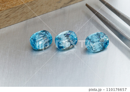 macro mineral faceted stone cut aquamarine on a gray background macro mineral faceted stone cut aquamarine on a gray background 110176657