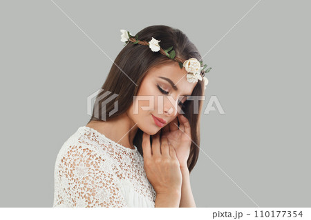 Bride woman brunette with long dark healthy wavy hair and makeup on gray background Bride woman brunette with long dark healthy wavy hair and makeup on gray background 110177354