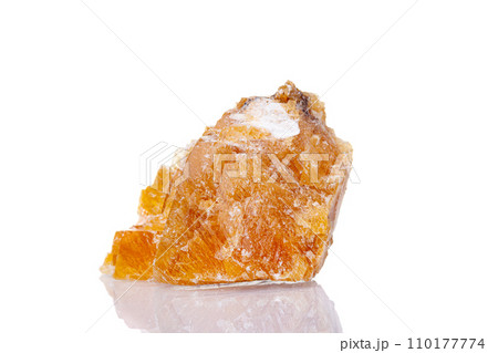 macro mineral stone yellow calcite on a white background 110177774