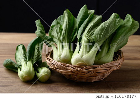 Bok choy or Pak choi (Chinese cabbage) in basket on wooden table with black background Bok choy or Pak choi (Chinese cabbage) in basket on wooden table with black background 110178177