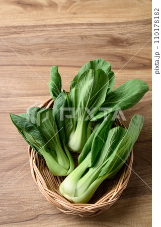 Bok choy or Pak choi (Chinese cabbage) in basket on wooden table, Organic vegetables 110178182