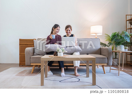 Two woman communicate with their friends and classmate via video link using a laptop and smartphone in the living room. Friends, friendship, time together Two woman communicate with their friends and classmate via video link using a laptop and smartphone in the living room. Friends, friendship, time together 110180818