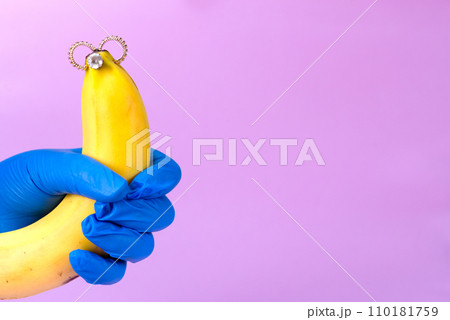 Intimate piercing. Minimal piercing concept. Banana with inserted iron decoration, piercing Intimate piercing. Minimal piercing concept. Banana with inserted iron decoration, piercing 110181759