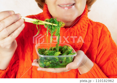 Woman eating japanese seaweed salad concept of woman on diet, healthy eating, healthy diet lifestyle 110182962