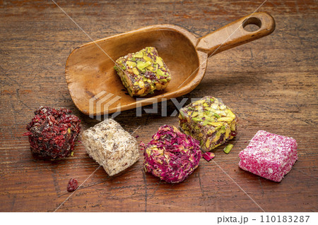 traditional Turkish delight (lokum) - soft, juicy, and chewy dessert from the middle east in a vintage wooden scoop 110183287