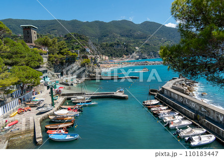 Italy, Monterosso,Italy, Monterosso,  beach and parasols in front of the giant, statue of the giant god Poseidon or Neptune 110183447